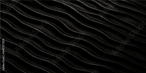 Black and white silk fabric texture with smooth flowing waves and elegant design background