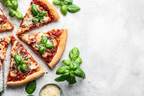 Sliced pizza with basil and cheese on parchment paper