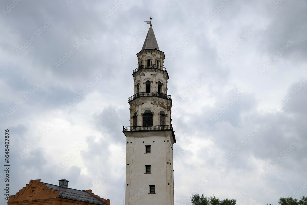 The photograph captures an ancient tower with a tilt similar to the Pisa Tower The photograph captures an ancient tower with a tilt similar to the Pisa Tower