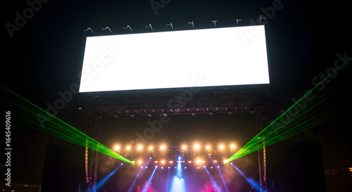 A large blank white screen mockup above a concert stage with a colorful light and laser show at night.