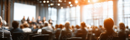 people attending business conference in auditorium