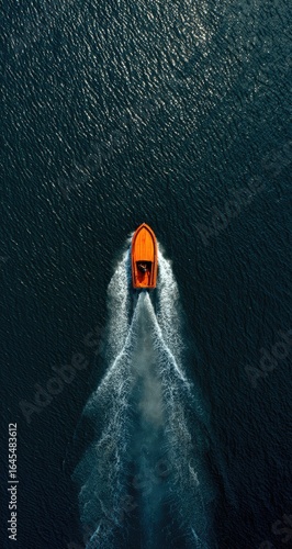 Wallpaper Mural An orange motorboat speeds across dark water, leaving a V-shaped wake.  The overhead shot emphasizes the boat's trajectory and the contrast between the vessel and the sea Torontodigital.ca