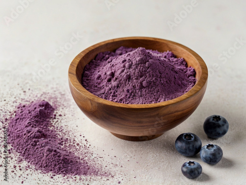 Vibrant purple powder in wooden bowl with blueberries blueberry powder fruit powder