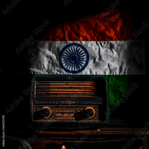 A classic brown wooden retro radio with a dial and speaker on a grunge background broadcasts sound