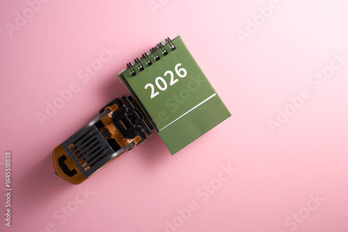 top view of toy forklift carrying 2026  calendar.