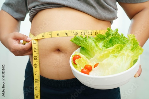 Fotografía Asian woman with fat belly big size overweight and obesity with healthy food