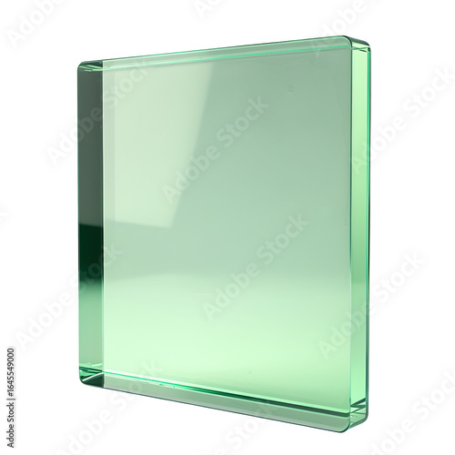 A close up view of a transparent green glass block against a black background in studio lighting