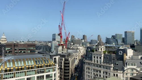 Rooftop pan over busy streets of the City of London Financial District and skyscrapers.