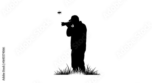 photographer captures fleeting moment silhouette of a nature photographer shooting a tiny insect in flight perfect for wildlife nature and photography blogs and websites