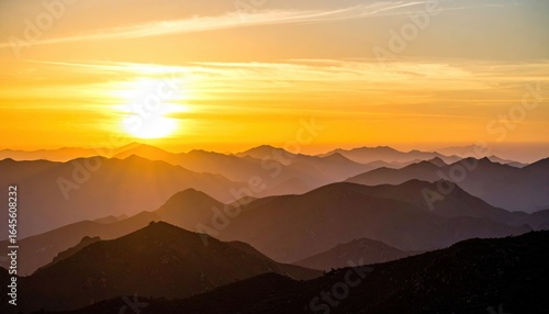 Wallpaper Mural Golden Dawn Over Mountainscape: A breathtaking panorama unfolds as the sun ascends, casting a warm, golden hue upon a majestic mountain range, painting the sky with vibrant colors.  Torontodigital.ca