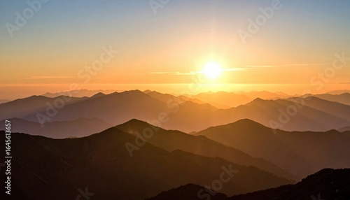 Golden Horizon: A breathtaking view of sun rise over a majestic mountain range, with the radiant sun casting a warm, inviting glow over the layered peaks and valleys.