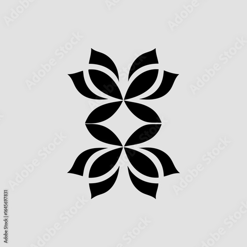 Abstract symmetrical black floral motif with overlapping petals on a light grey background