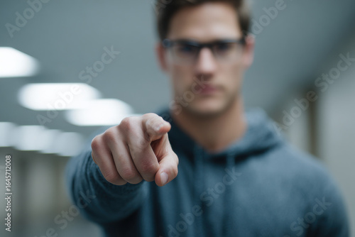 person confidently demonstrates important gesture of pointing emphasizing significant object nearby