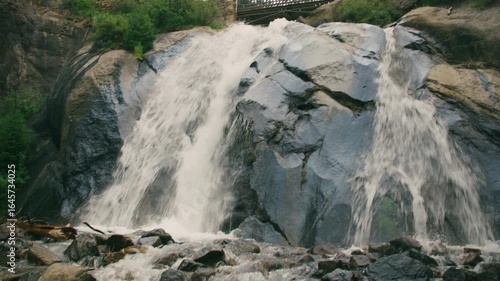 Pan across small stream to beautiful Colorado waterfall