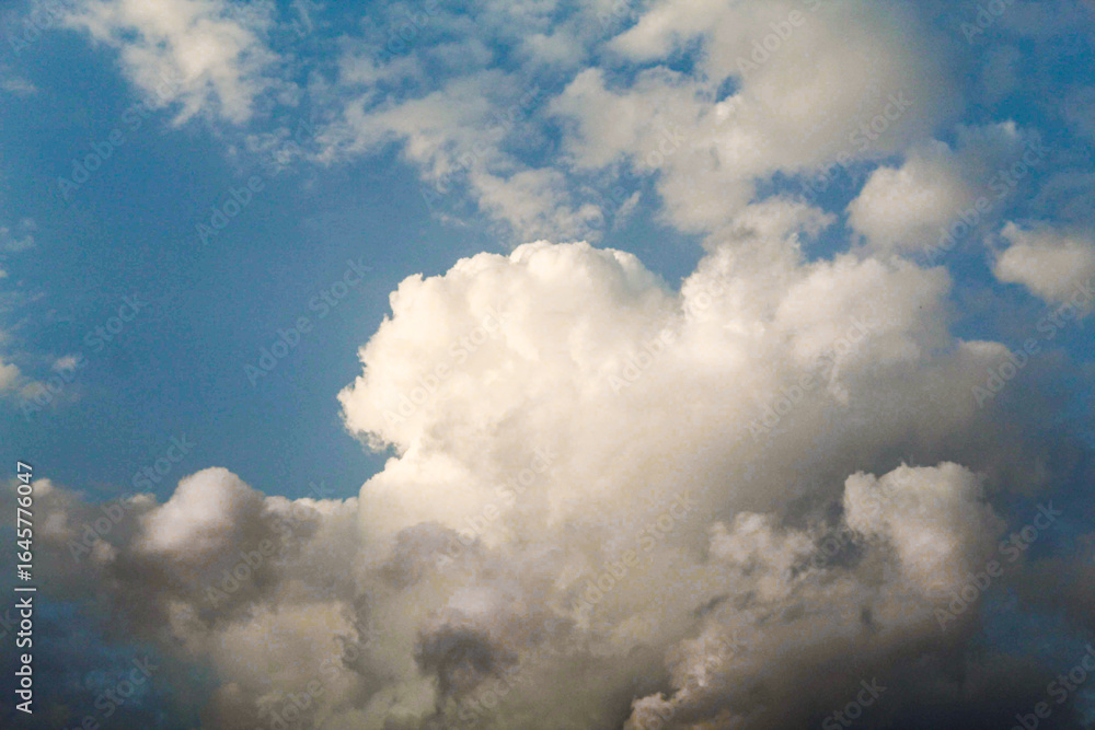 Obraz premium White fluffy cumulus clouds on blue sky