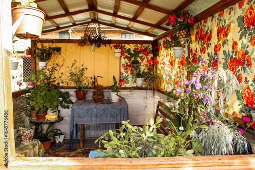 Fototapeta Naklejka Na Ścianę i Meble -  Vintage gazebo dining table with outdoor wooden bench with flowers