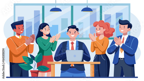 A group of people are gathered around a table, with one man in a suit standing in the middle. The group is smiling and clapping, indicating a positive and friendly atmosphere