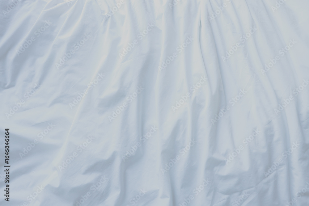 Fototapeta premium Abstract white fabric background. Elegant and soft material with wavy folds and a smooth texture. Copy space