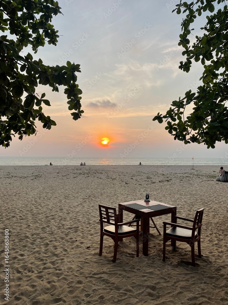 Fototapeta premium Sunset Beach Dining Table in Koh Chang, Thailand
