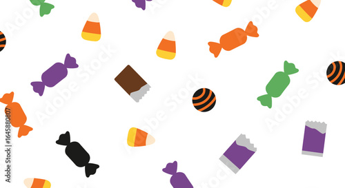 A pattern of assorted Halloween candies including candy corn and chocolate.