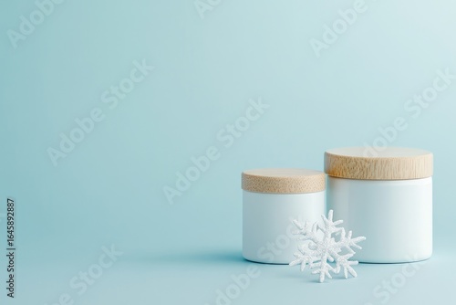 Three white jars with cork lids and a snowflake on blue