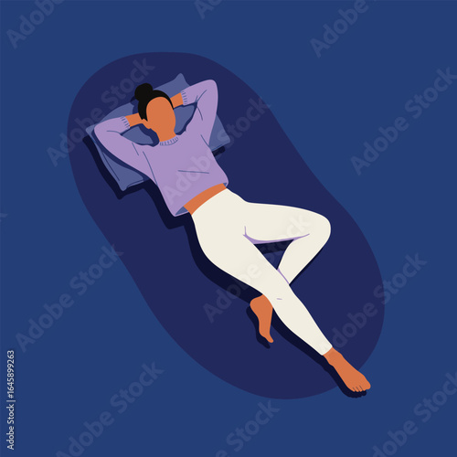 A woman lying down on a mat, resting comfortably with her hands behind her head, enjoying a moment of peace and relaxation in a serene setting