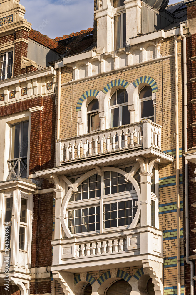 Fototapeta premium ornate historic townhouses with distinct architectural styles. The scene captures the charm of coastal architecture in Dunkirk, France