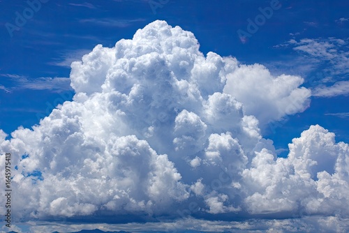 Fluffy cumulus clouds against a vibrant blue sky