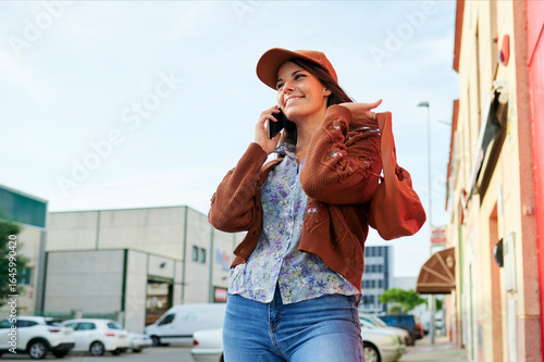 Woman walking down the street talking on mobile phone