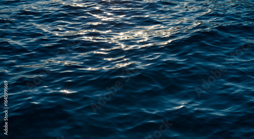 Fototapeta Naklejka Na Ścianę i Meble -  Sunlight reflecting on ocean waves, Sea with glistening sun reflection background 