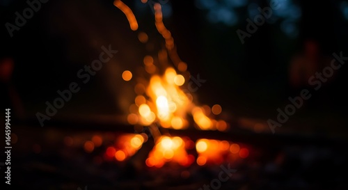 Abstract blurred campfire with glowing bokeh at night