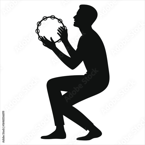 Silhouette of a man playing tambourine while crouching, rhythmic percussion performance, black and white isolated image, musical expression, live entertainment, traditional music instrument