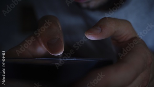 Smartphone and social network addiction concept. Hands using smartphone in bed at night