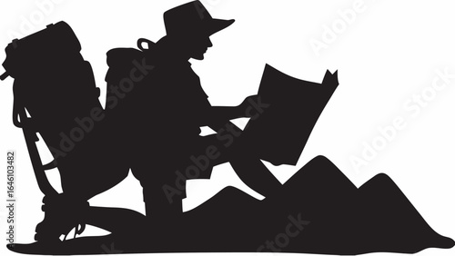 Silhouette of a hiker with a backpack and hat reading a map while kneeling on mountainside terrain