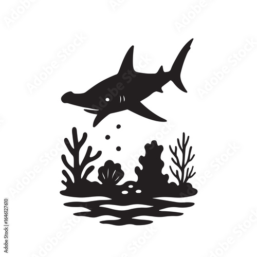 Hammerhead shark gliding over coral reef