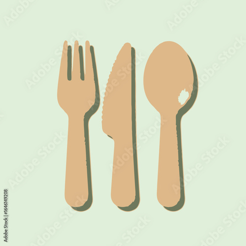 Wooden fork knife and spoon on a light green background.