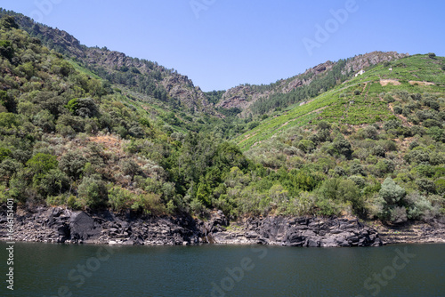 Boat tour through the Sil Canyon in Ribeira Sacra, Galicia, Spain, departing from Embarcadoiro da Ponte do Sil, Monforte de Lemos. Scenic river and vineyards.