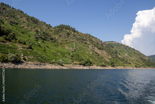 Boat tour through the Sil Canyon in Ribeira Sacra, Galicia, Spain, departing from Embarcadoiro da Ponte do Sil, Monforte de Lemos. Scenic river and vineyards.