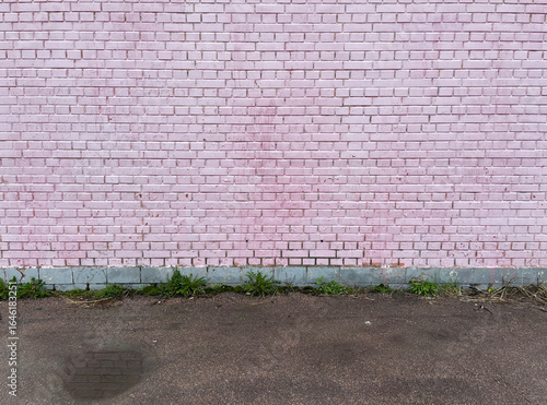 Old brick pink wall and asphalt floor