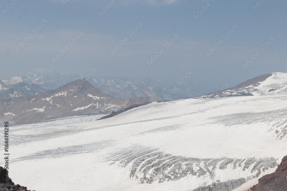 Obraz premium The cracked Bolshoy Azau glacier on the slopes of Elbrus in midsummer