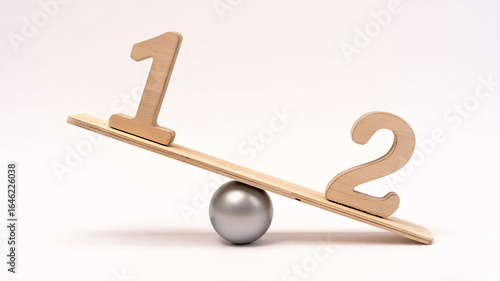 Wooden numbers one and two on a balanced seesaw symbolize disparity and comparison