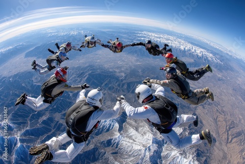 Skydivers perform synchronized formation at high altitude over snow-capped mountains