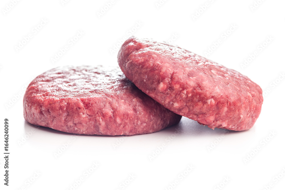 Raw burger beef patties isolated on white background. Raw burger beef patties isolated on white background.