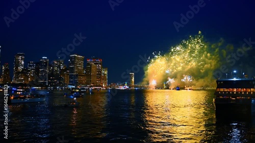 Spectacular firework show in the night sky of New York. Metropolis skyline and bridge at backdrop.