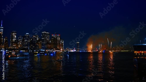 Celebration with stunning fireworks in modern New York, USA. View on the city skyline and fantastic show from the river at night.