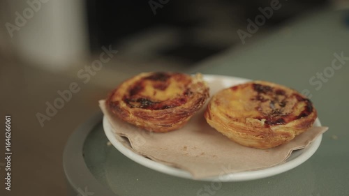 Close-up of two pastel de nata custard tarts on a plate