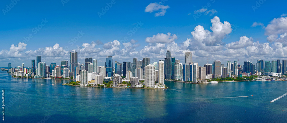Fototapeta premium Aerial panorama of Brickell in Miami. Downtown Miami skyline on a sunny day. Scenic view of Miami Beach and Brickell. Brickell famous landmarks. Miami downtown landscape.
