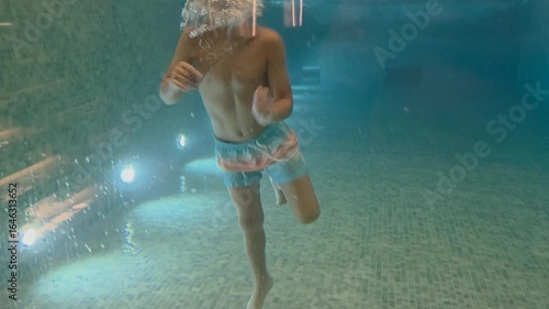 boy jump in a pool - hotel concept