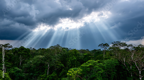 Crepuscular Rays Piercing Monsoon Clouds Over Rainforest With Wide-Angle Composition And Mystical Shadows