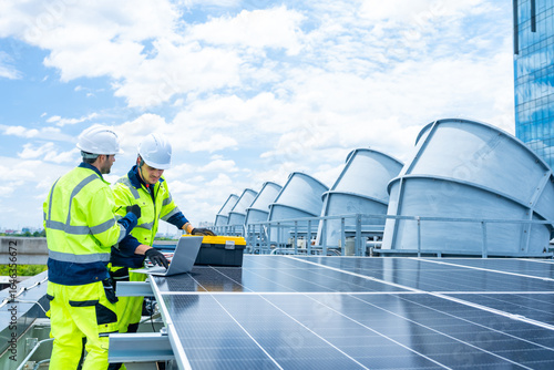 Solar cell, electricity alternative renewable clean energy for environmental conservation, sustainability technology. Male engineer maintaining solar panel system on construction site building rooftop